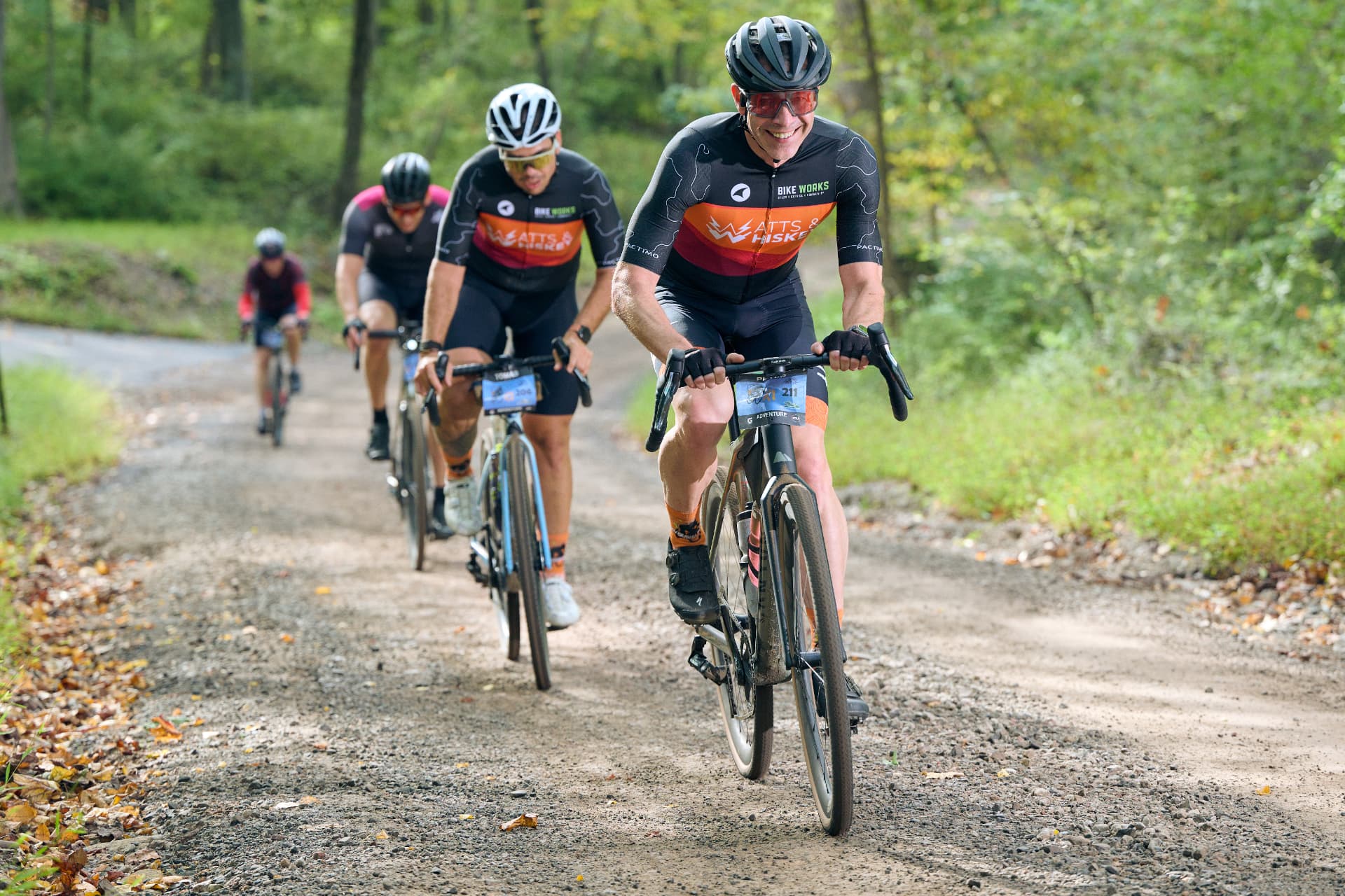 Riders grinding up a long dirt climb