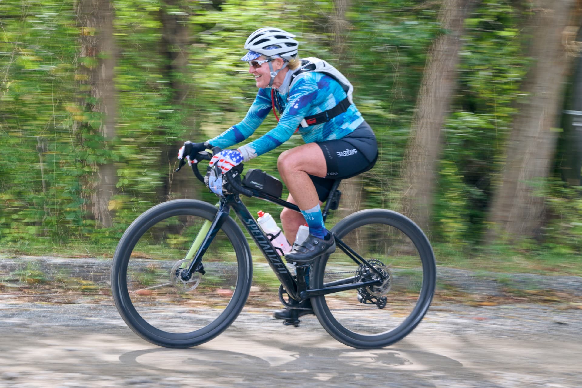 Smiling rider flying along a gravel road